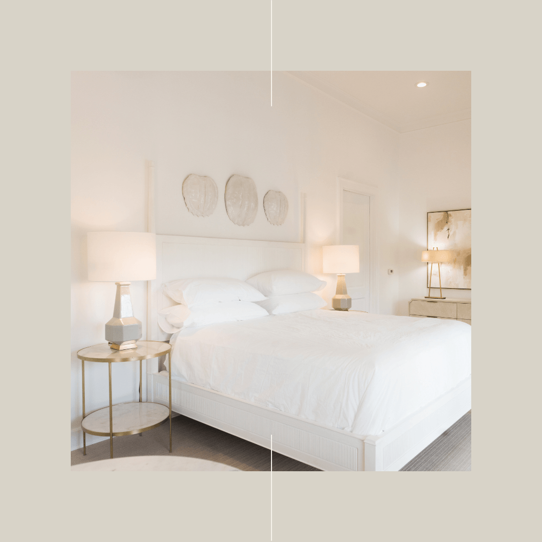 A boutique hotel bedroom with a bed and two lamps