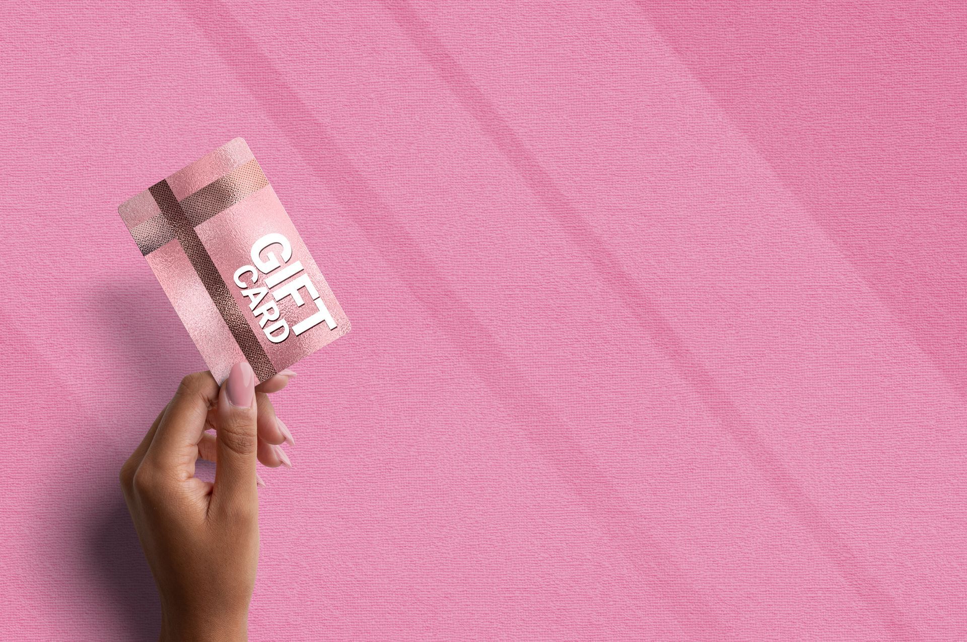 Female hand holding a gift card — Morrisville, PA — Bally Beauty
