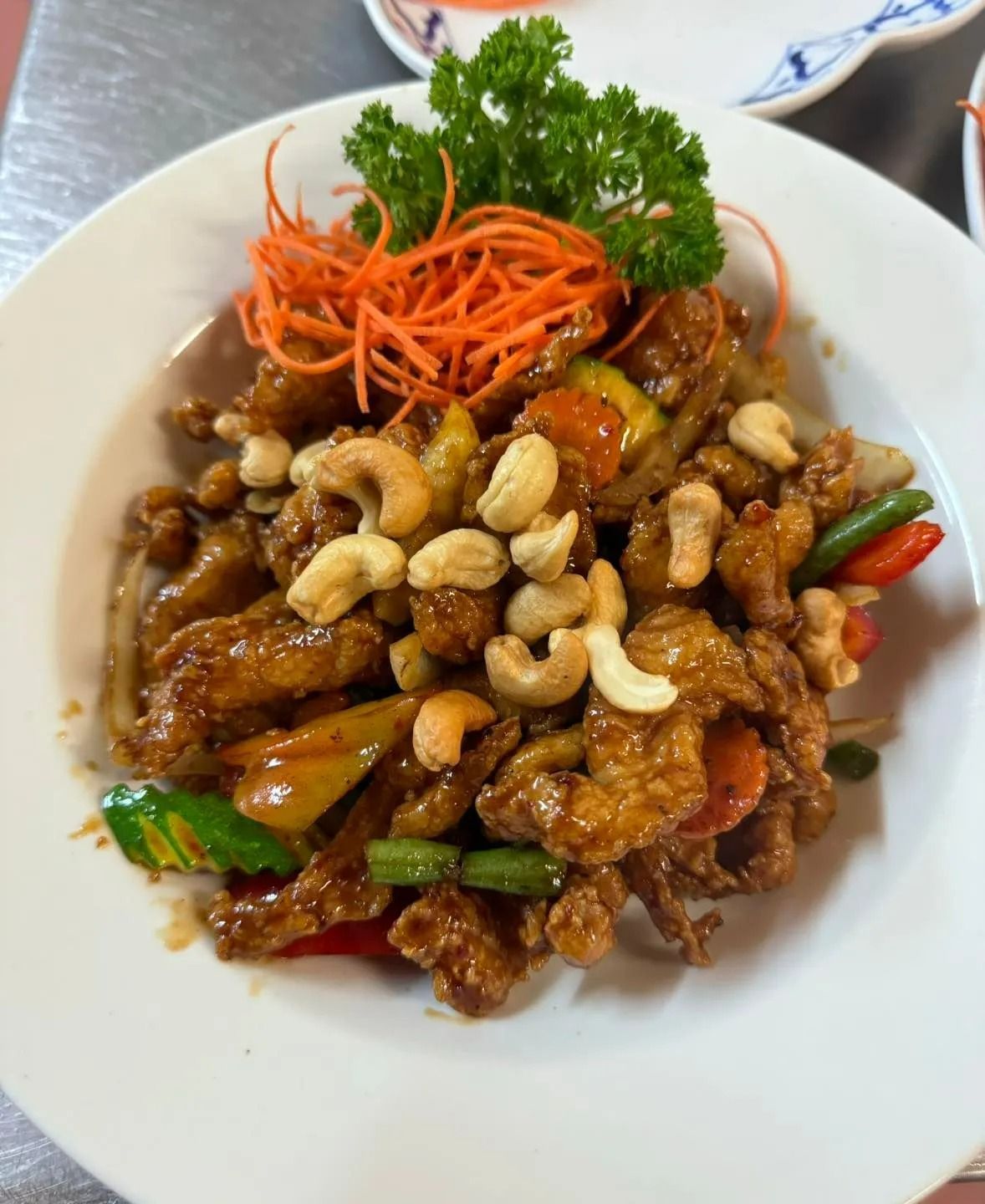 Cashew Chicken Dish With Vegetables, Garnished With Carrot and Parsley — Thai Taste Restaurant in Norman Gardens, QLD