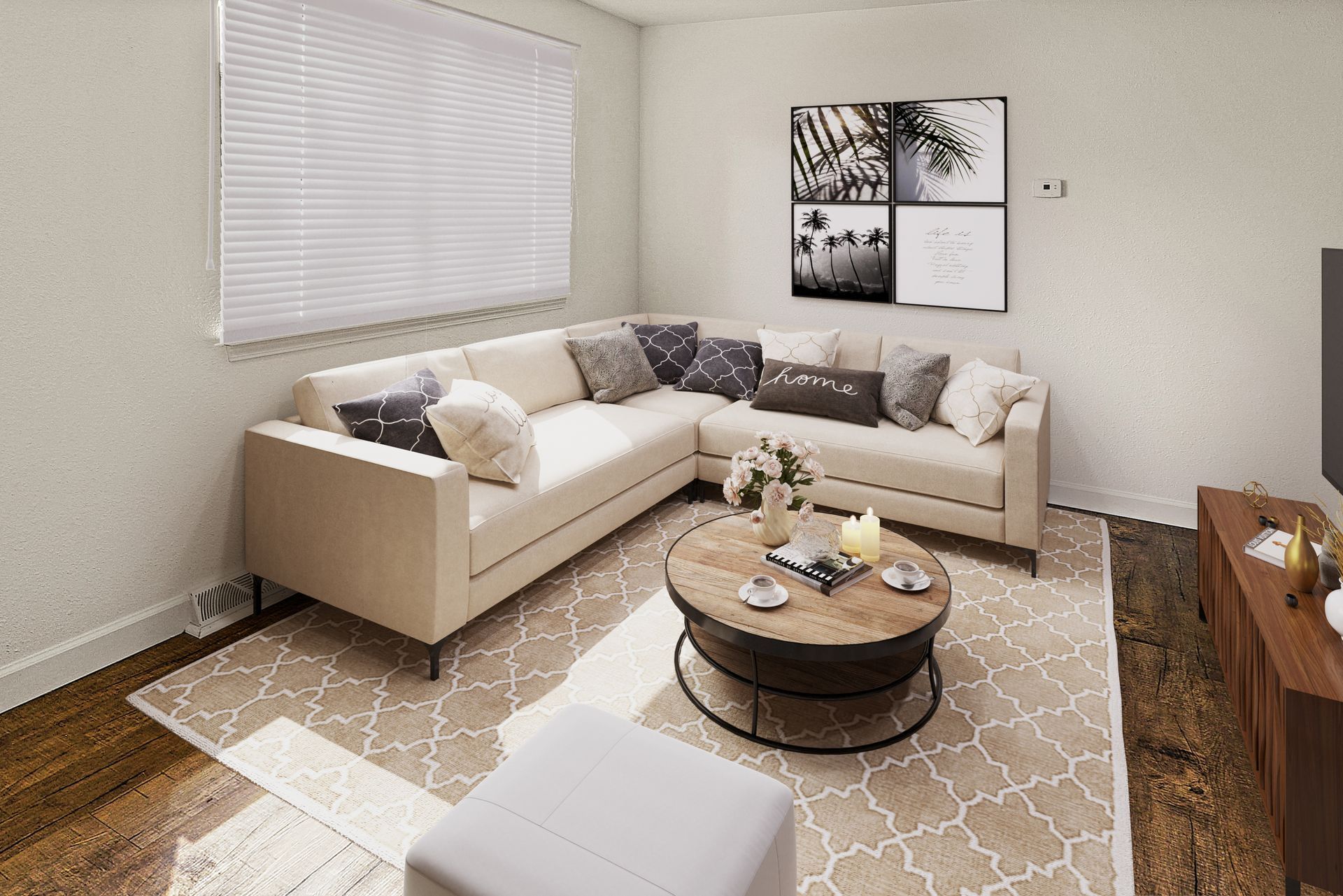Modern living room with beige sectional sofa, round coffee table, patterned rug, and wall art.