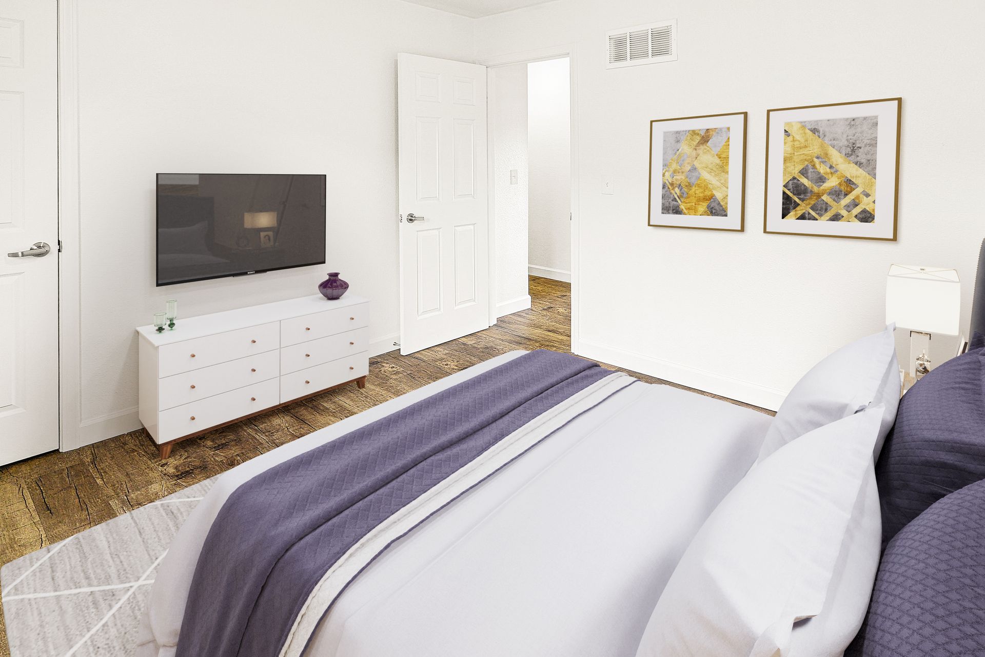 Modern bedroom with a bed, wall-mounted TV, white dresser, and two framed pictures on the wall