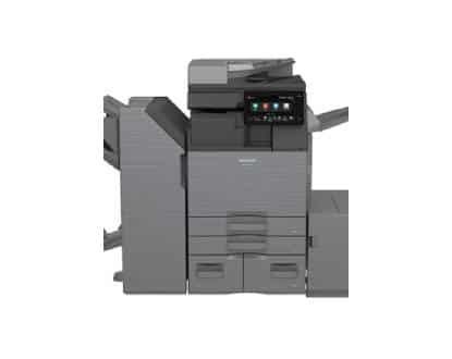 Two copiers are sitting next to each other in a room.