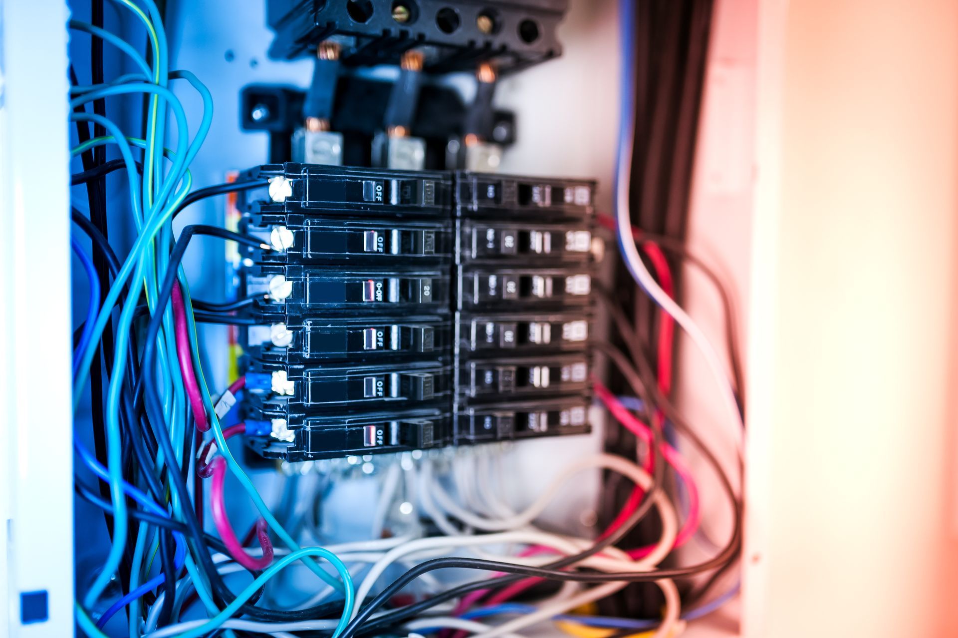 Close-up of a server rack with stacked hard drives and tangled cables inside a computer cabinet