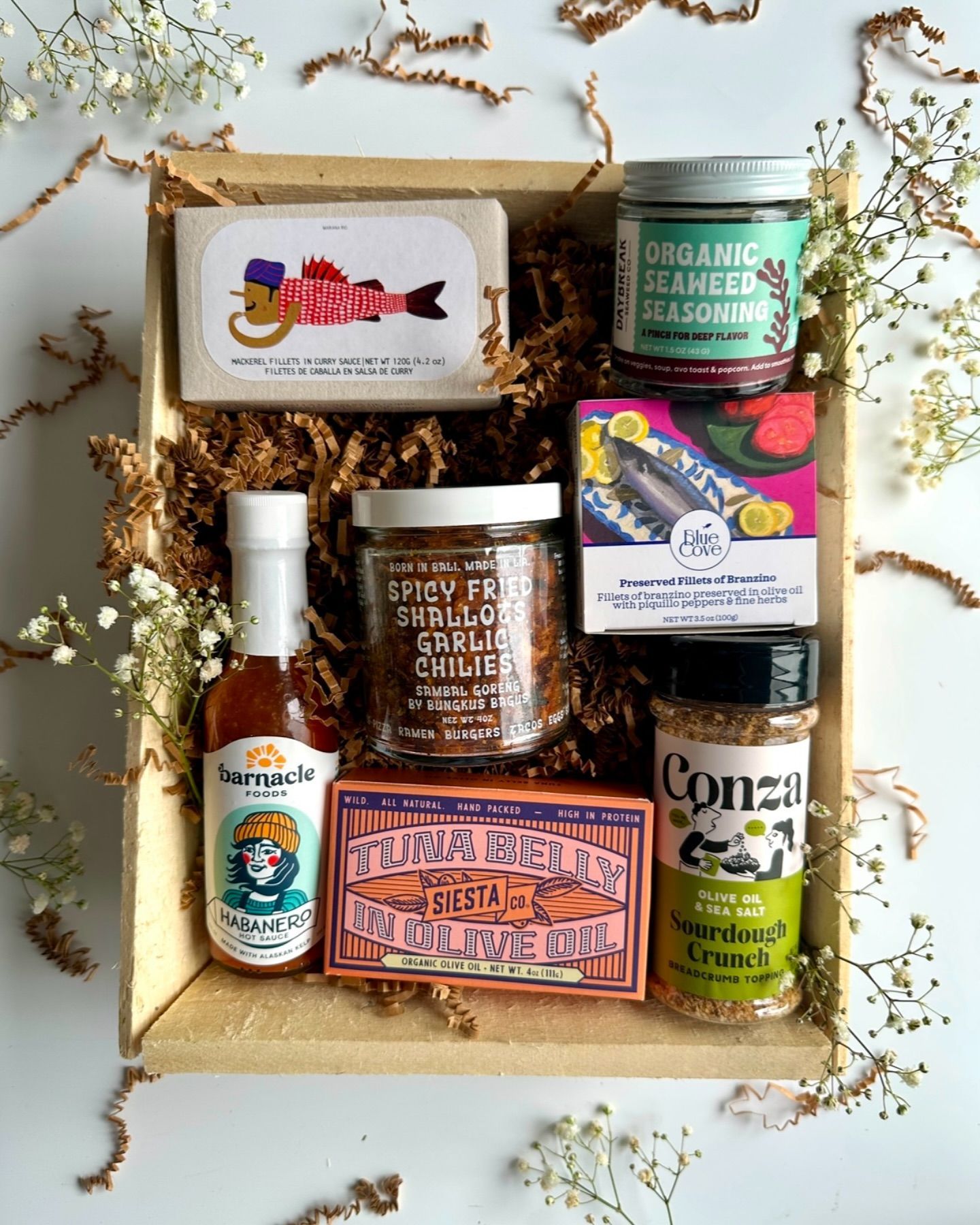 Wooden gift box with various seafood and seasoning jars.