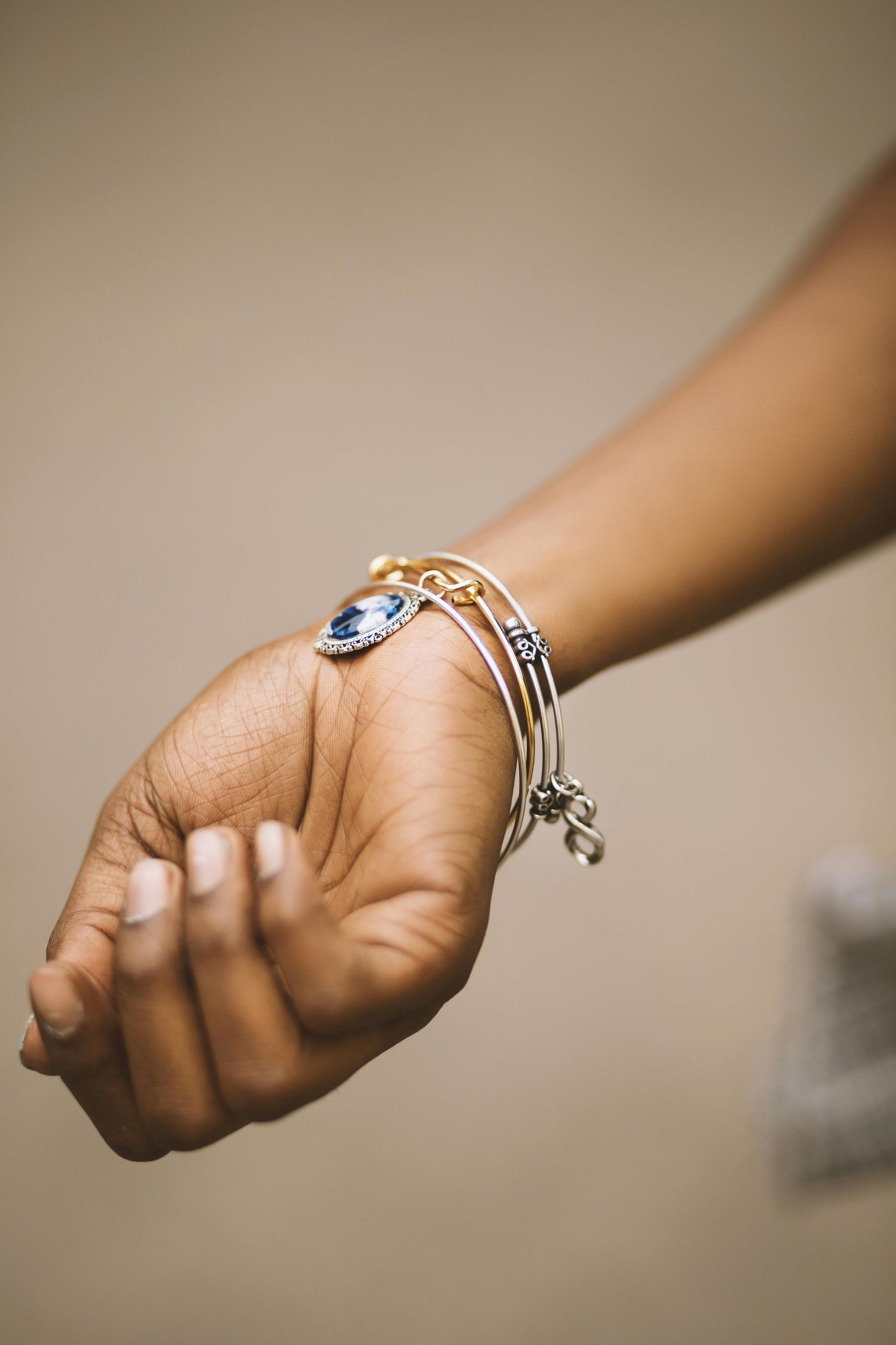 A woman is wearing a bracelet on her wrist.