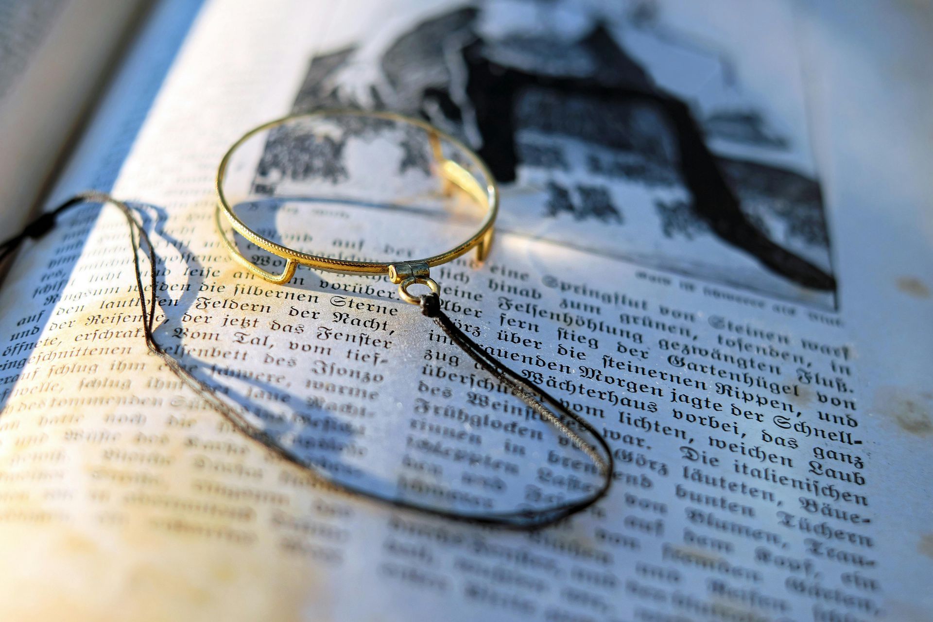 A magnifying glass is laying on top of an open book