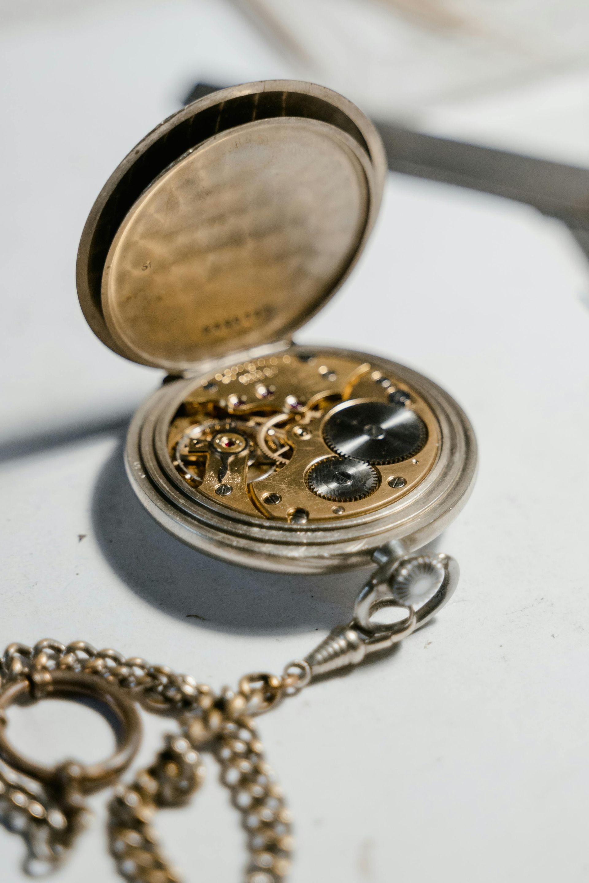 A close up of a pocket watch with the lid open.