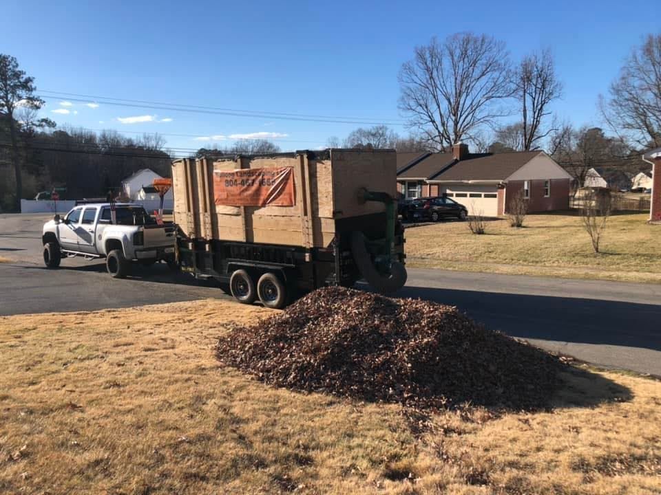 A dump truck is pulling a trailer full of mulch.