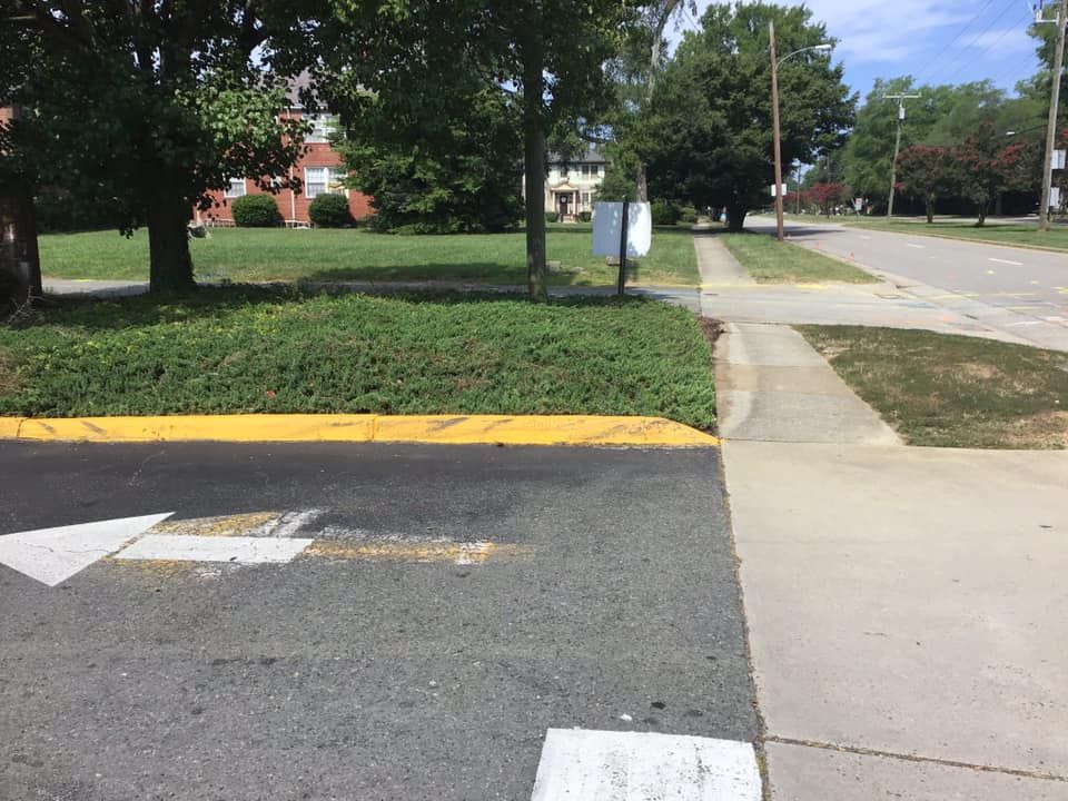 A white arrow is painted on the side of the road