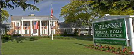 A funeral home with a sign in front of it