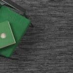 Green envelopes and a card on a dark textured surface