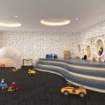 Children’s playroom with toy cars, colorful wall art, and a curved gray-and-white play structure