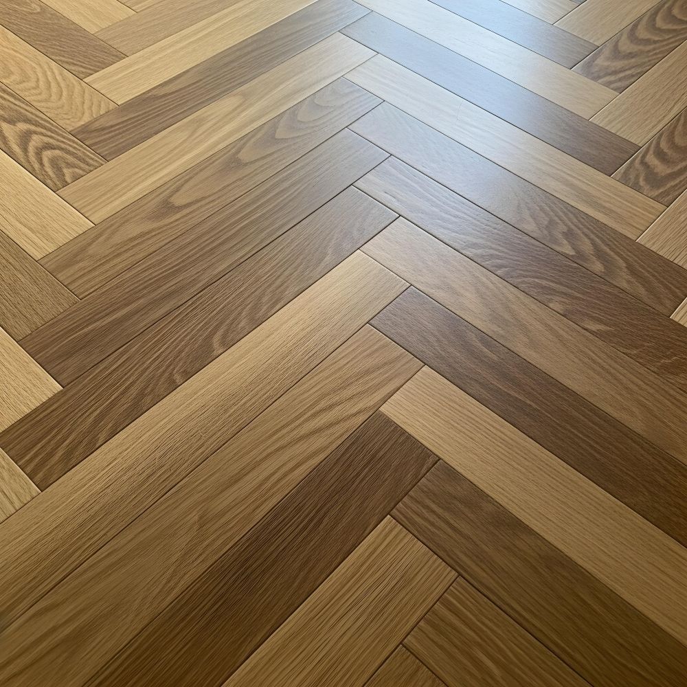 A herringbone-patterned wooden floor featuring alternating planks of light and medium-brown stained oak.