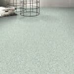 Empty room with light green carpet and wire chair bases near the wall