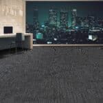 Modern office interior with a dark city skyline mural and gray carpet flooring