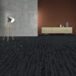 Modern minimalist room with dark carpet, gray and brown walls, and a bench with small decor items.