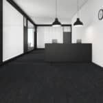 Minimal black-and-white modern office with dark flooring, glass walls, and two hanging pendant lights.
