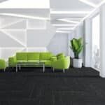 Modern lounge with lime green sofas, white walls, dark carpet, and a potted plant by large windows