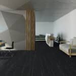 Modern minimalist living room with dark floor, white walls, wood column, sofa, and small seating area
