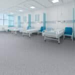 Empty hospital waiting room with blue chairs and large windows