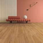 Minimal living room with pink and striped walls, wooden floor, red sofa, and a floor lamp