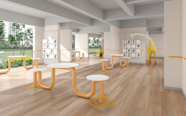 Bright modern fitness studio with wooden floors, orange exercise bars, and white benches by large windows