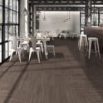 Modern industrial café with white chairs and tables in a bright, open loft space
