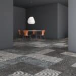 Modern gray dining room with a wooden table, chairs, pendant light, and patterned carpet