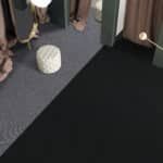 White patterned ball on a dark carpeted floor near a doorway