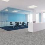 Modern office conference room with glass walls, black chairs, blue accent wall, and carpeted floor