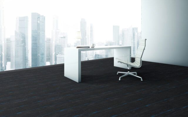 Minimal office with white desk and chair on dark floor before a bright city skyline.