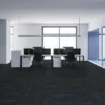 Modern office interior with desks, chairs, and large windows looking out to the sea