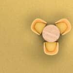 Three yellow petal-like shapes around a beige circle on a mustard background