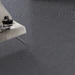 Close-up of a gray textured surface with a small white platform in the corner