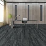 Modern minimalist office with a desk, chair, wall cabinets, and dark carpeted floor