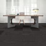 Minimalist dining table with chairs in a bright room on a dark carpet