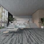 Modern minimalist lobby with gray carpet, stepped seating, wood walls, and potted plants