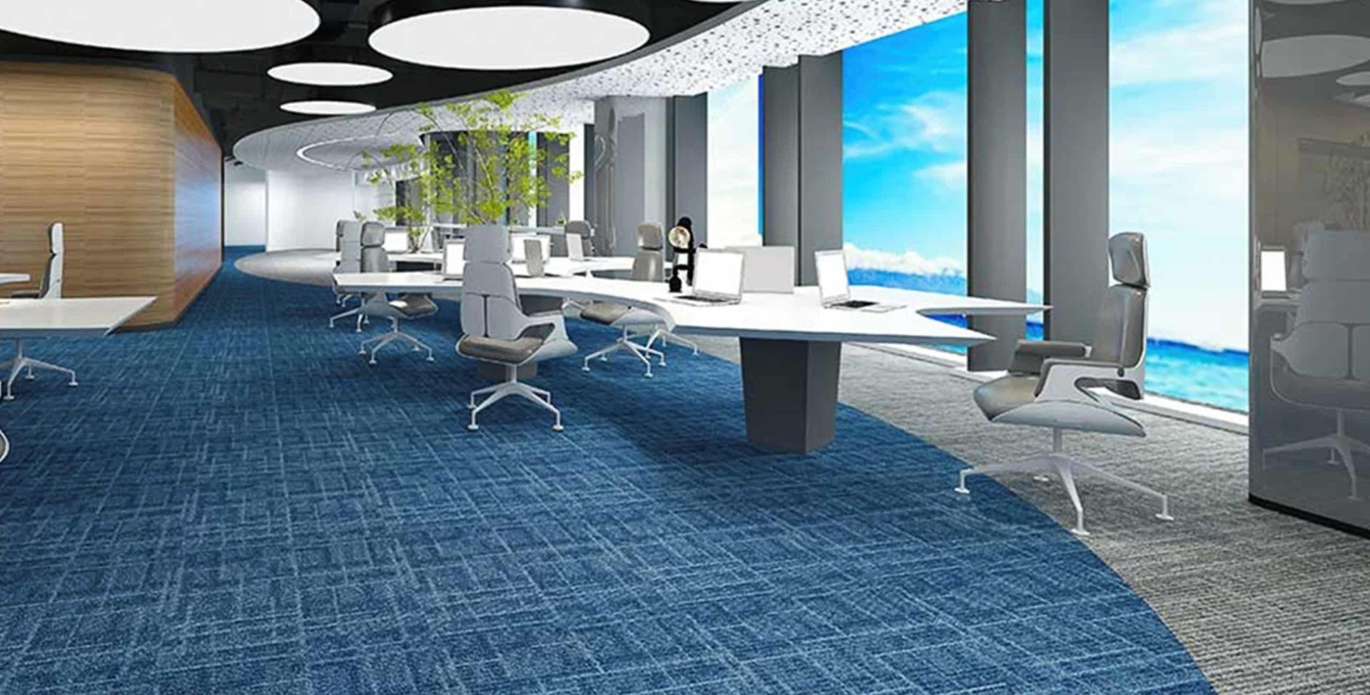 Modern office space featuring white ergonomic desks, gray swivel chairs, blue carpet, and floor-to-ceiling windows.