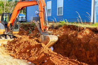 Excavator digging soil in backyard Excavator digging soil in backyard