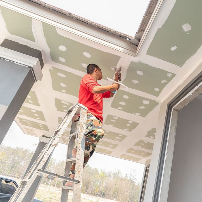 Man Doing Drywall Repair Man Doing Drywall Repair