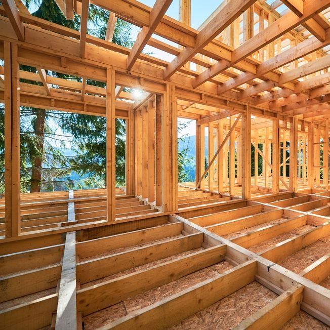 Dywall And Painting Materials The inside of a wooden house under construction.