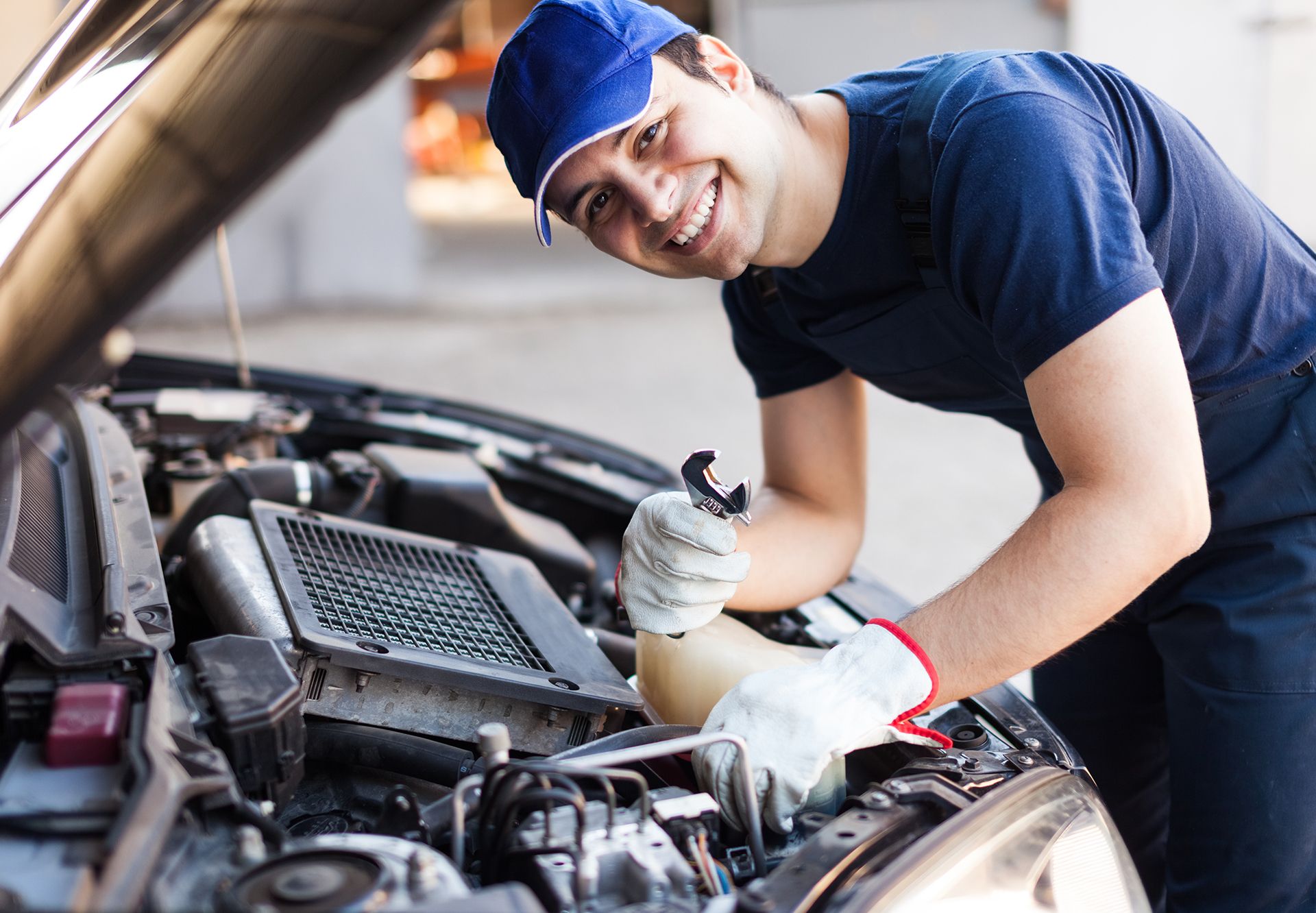 Mechanic Working On A Car Engine