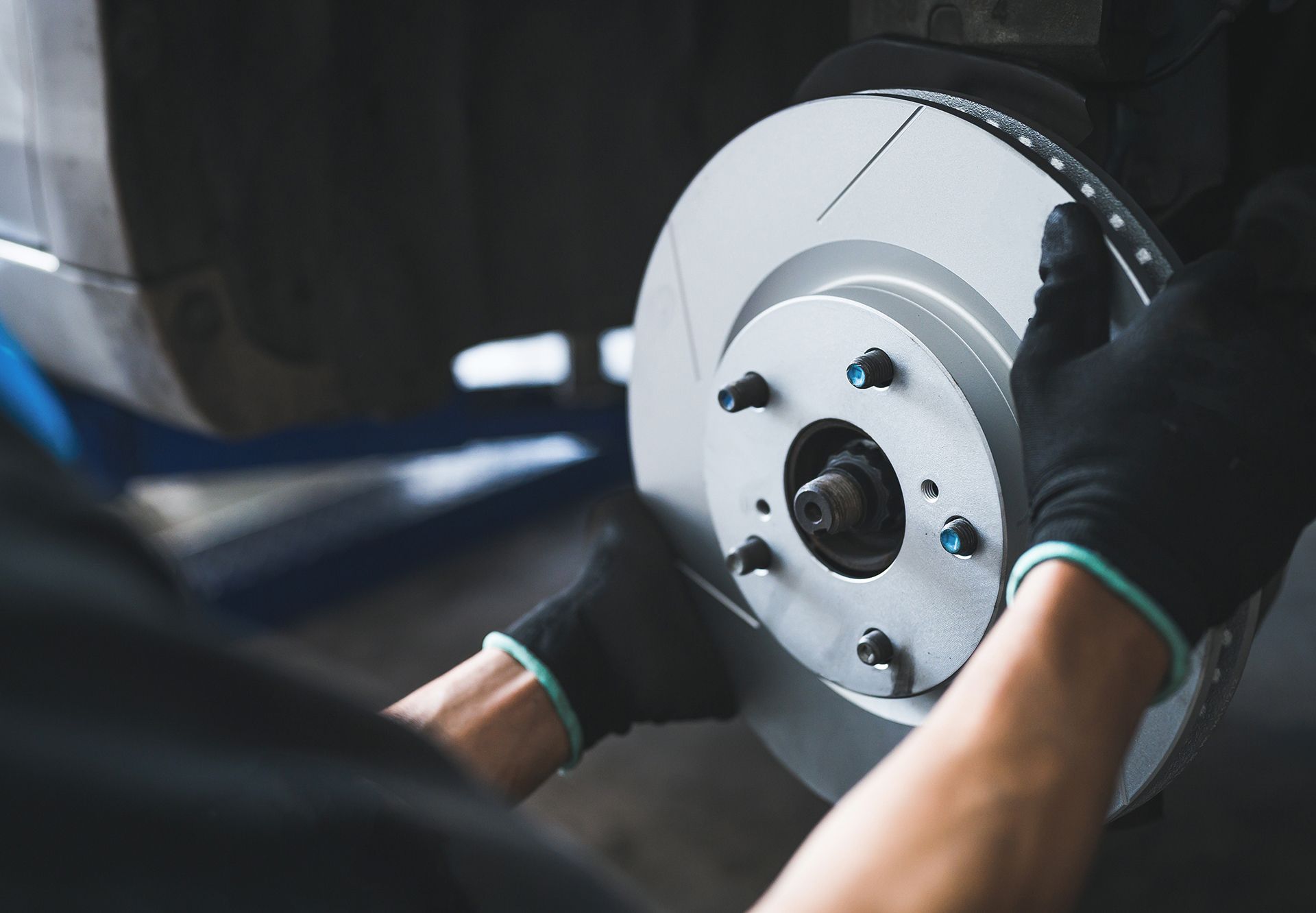 Auto Mechanic Installing A New Six Slot Brake Rotors
