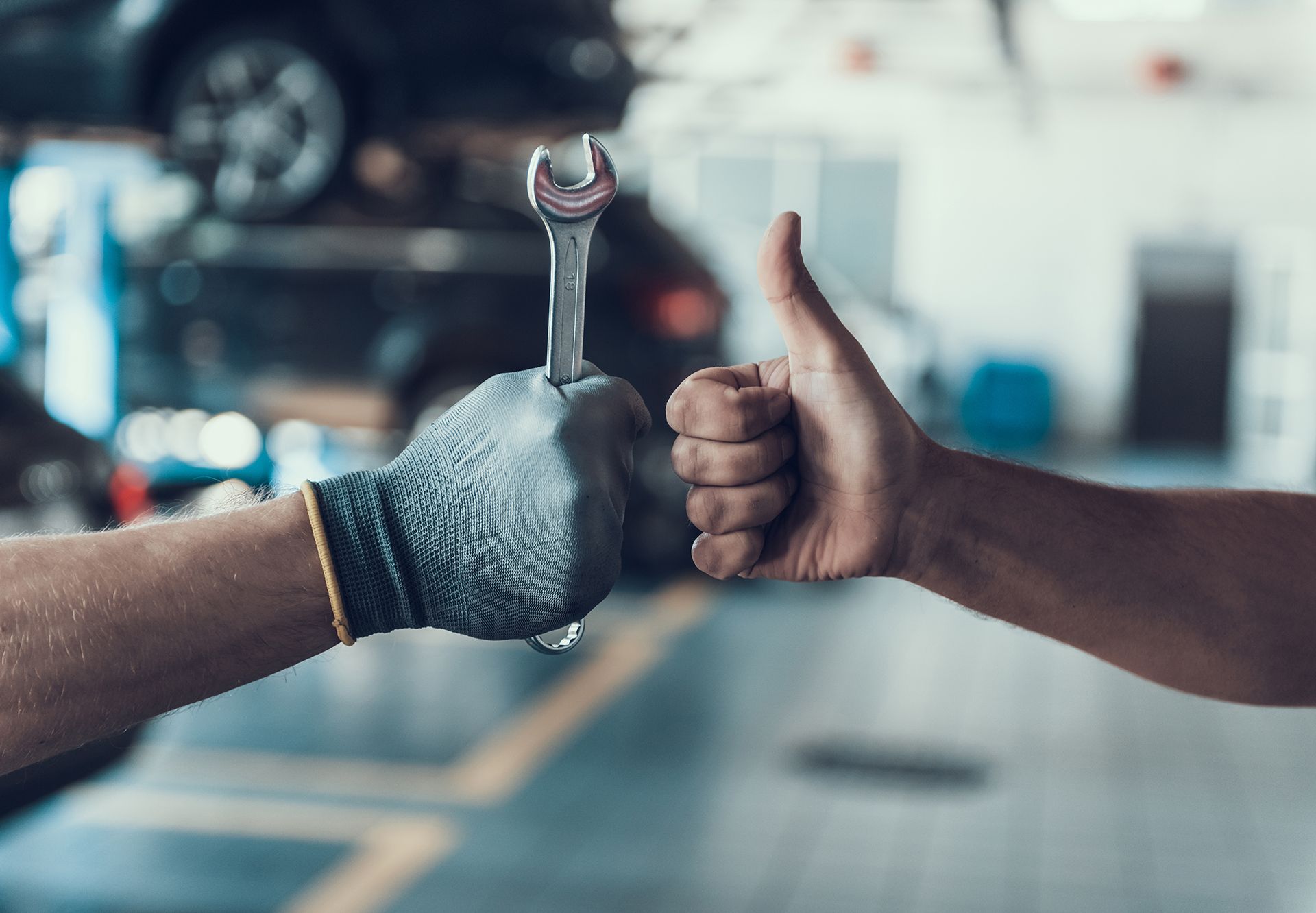 Close-Up Thumb Up And Mechanics Hand With Tool
