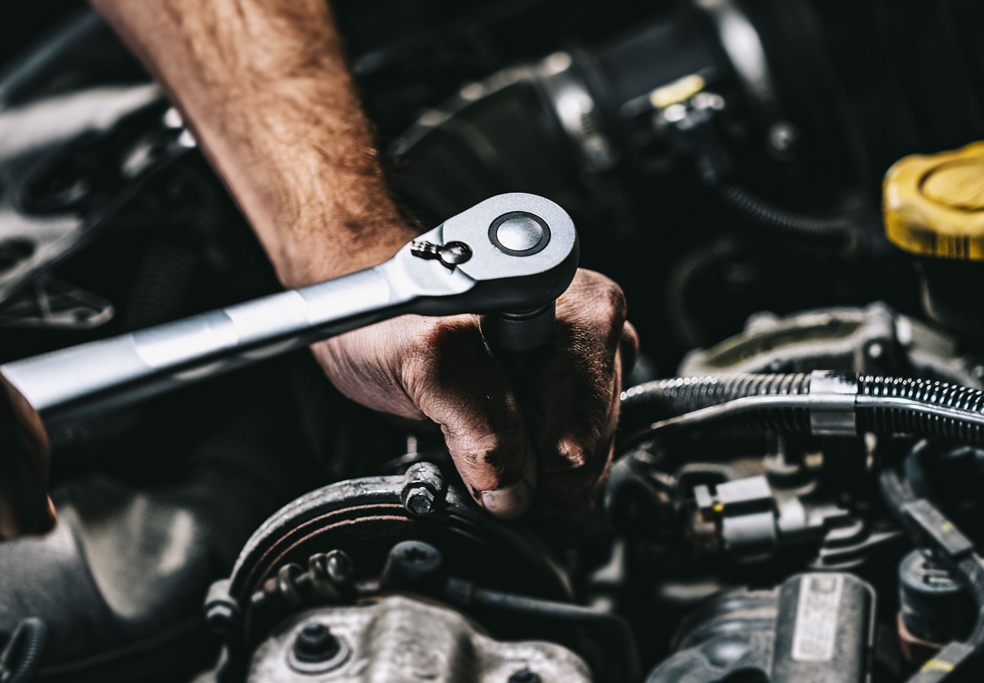 Worker Repairing Car Engine