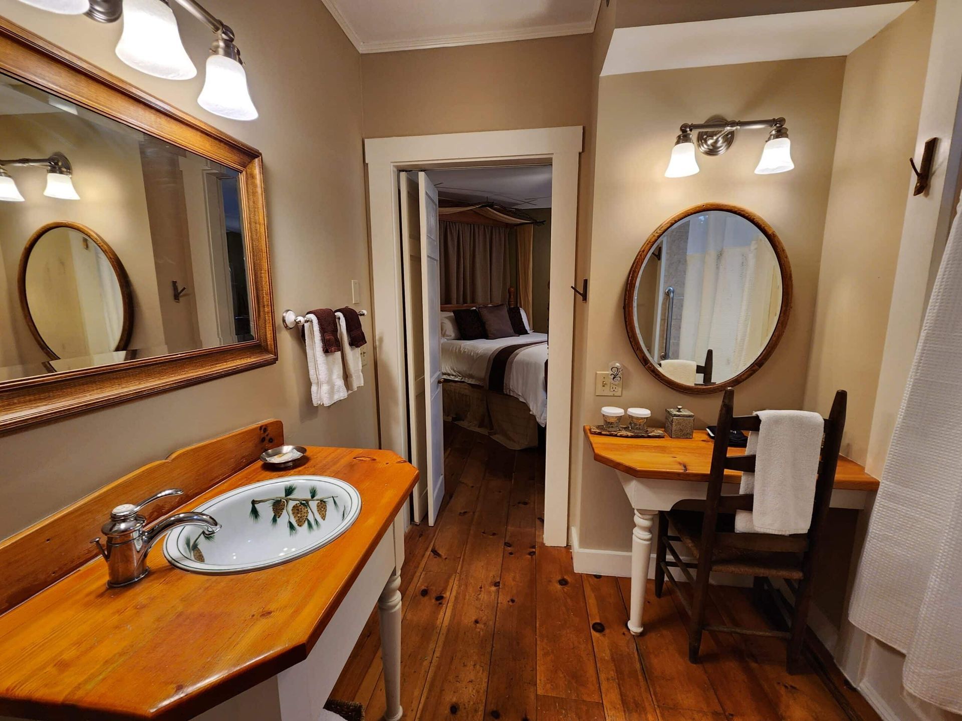 A bathroom with a sink , mirrors and a chair