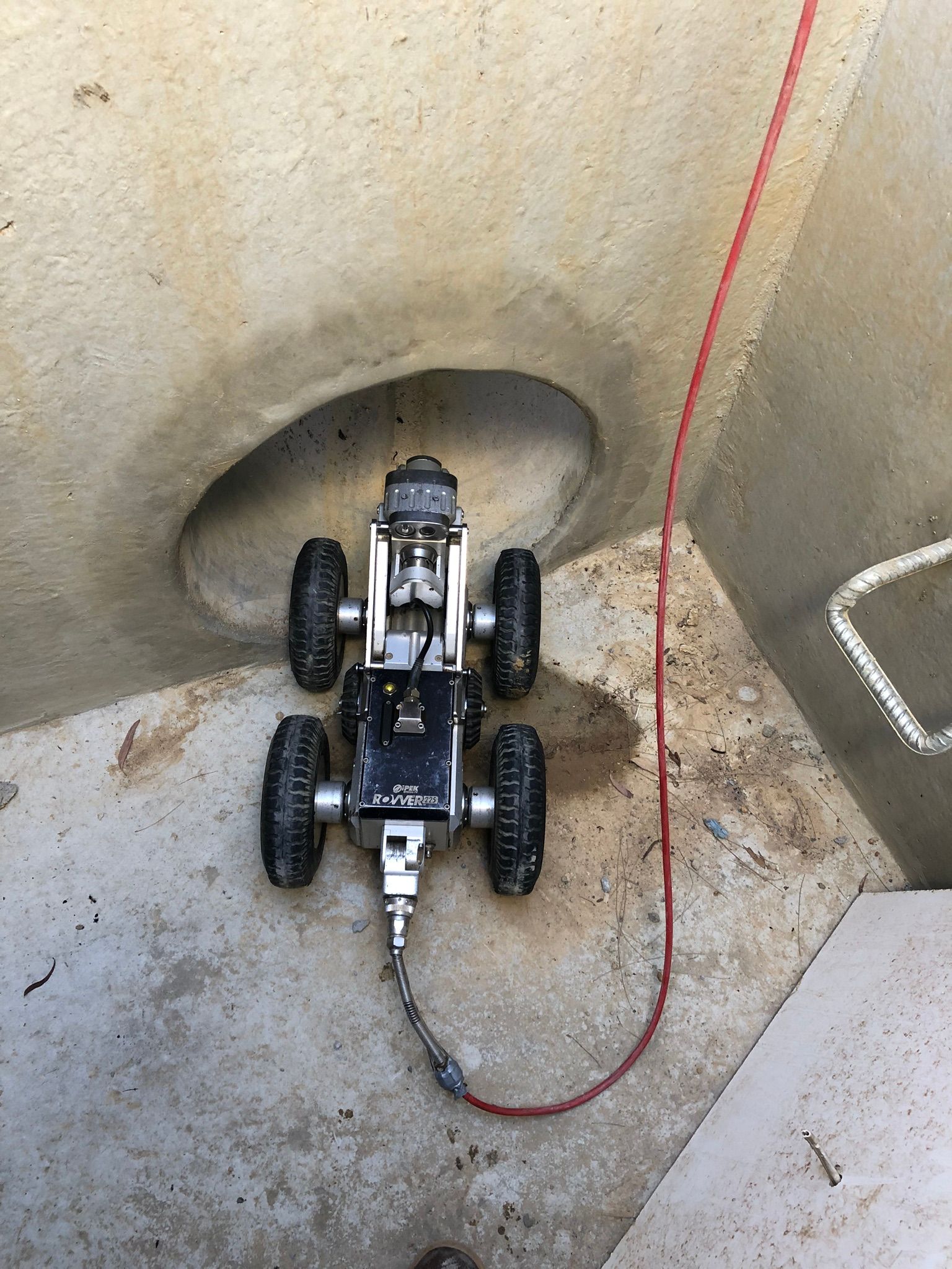 Robot inspection device in a concrete structure, connected to a red cable — Pro Pipe Solutions in Goulburn, NSW