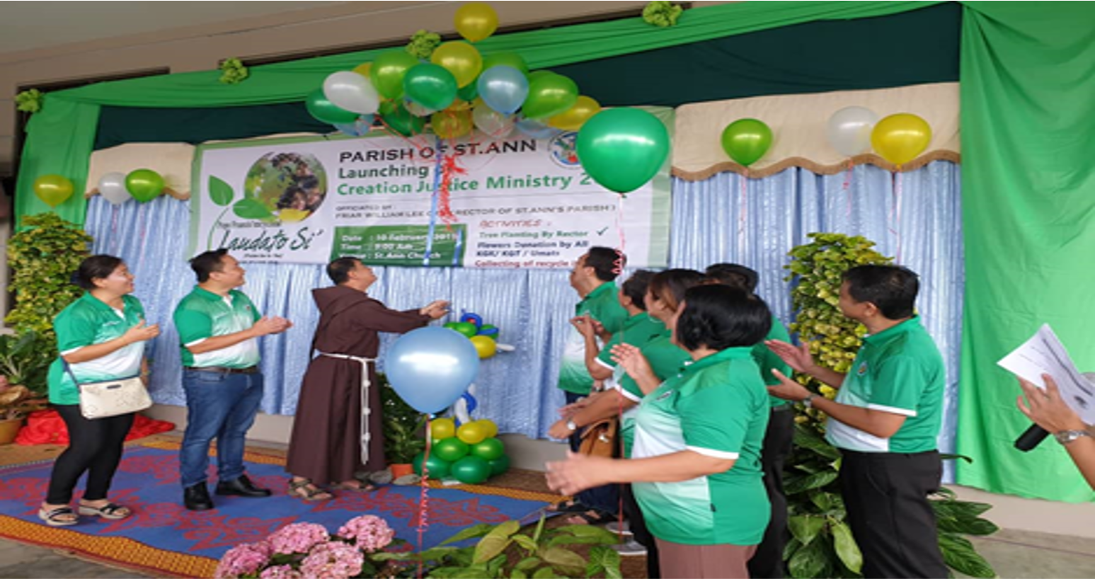 Group launches environmental justice ministry, balloons and banner on stage.