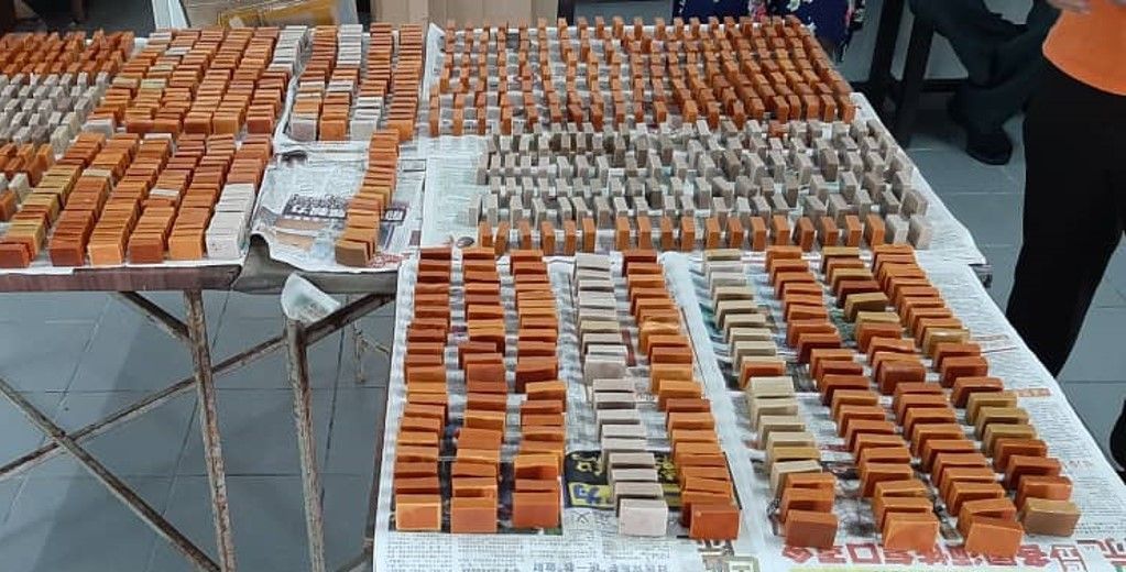 Wooden blocks arranged on a table, varying in color from light to dark brown.