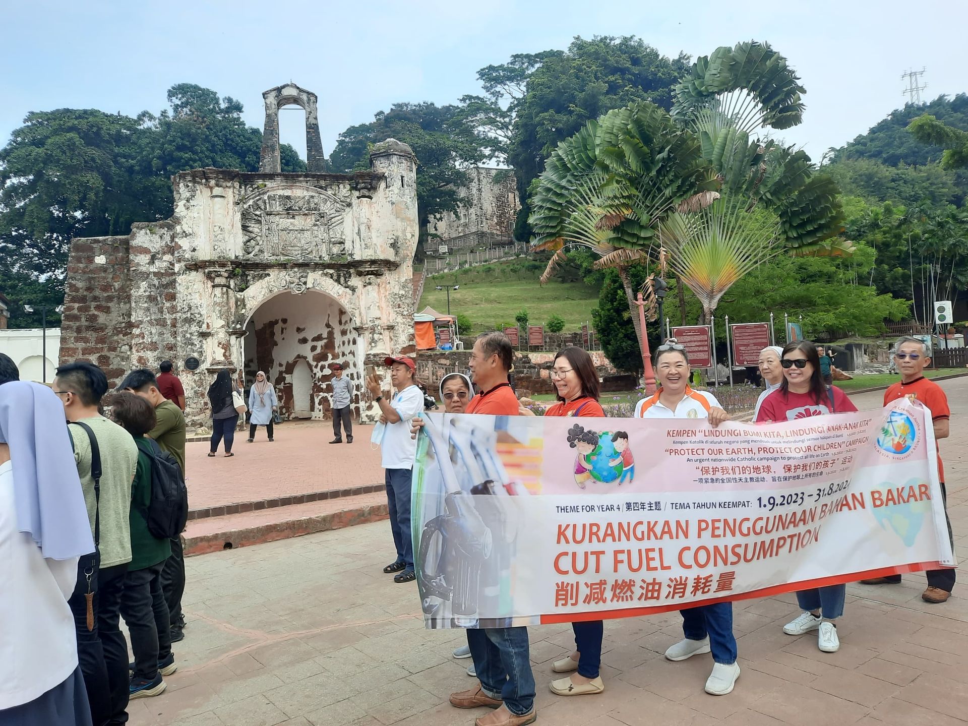Group of people holding a banner that says